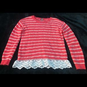 Beautiful orange shirt with white stripes, and a beautiful design at the bottom,